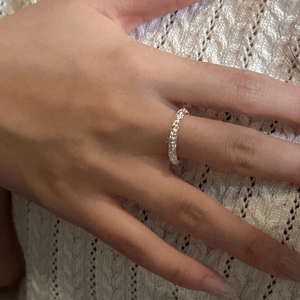 Minimalist S925 sterling silver ring featuring a hand-hammered texture on woman's index finger