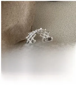 Detail of S925 sterling silver open ring featuring an intricate hollow mesh texture