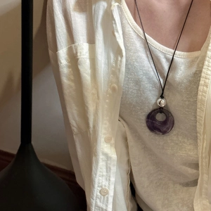 Minimalist S925 sterling silver necklace with a purple mineral pendant on a black cord