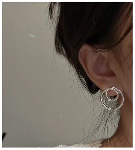 Close-up of S925 sterling silver earrings with a minimalist hollow double hoop design