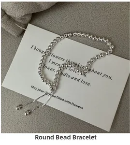 Detailed view of polished silver bead bracelet with adjustable sliding drawstring closure