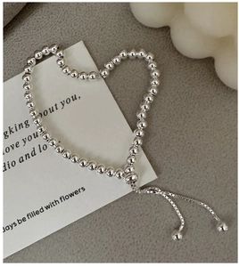 Detailed view of S925 sterling silver beaded bracelet with adjustable drawstring closure