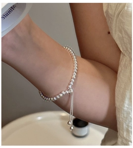 Detail of adjustable S925 sterling silver beaded bracelet with slide closure and charms