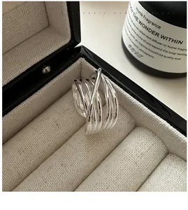 Macro shot of silver multi-layer crisscross ring displayed on a velvet jewelry box