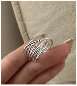Close-up of S925 sterling silver multilayer overlapping ring with polished finish