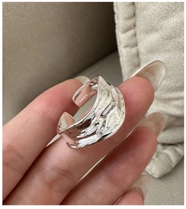 Detail of S925 sterling silver ring featuring irregular lava texture and adjustable band