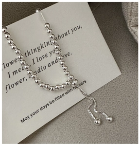 Detail of adjustable S925 silver beaded bracelet with sleek box chain and spherical toggle