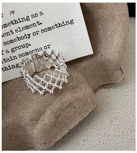 Detailed macro view of S925 sterling silver hollow woven lattice ring with adjustable band