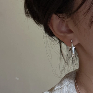Minimalist 925 sterling silver square hoop earrings with polished finish on model