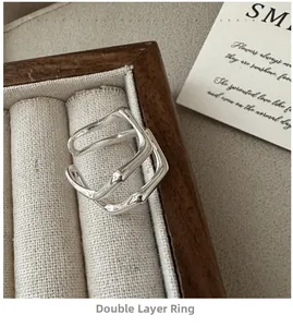 Detail view of a double-layer S925 sterling silver wave ring in a luxury jewelry box