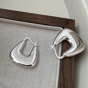Polished 925 sterling silver square hoop earrings on a textured wooden jewelry tray