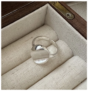 Macro detail of S925 sterling silver ring with brushed texture in a wooden jewelry box