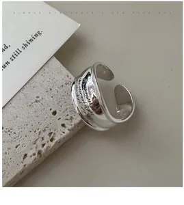 Macro shot of S925 sterling silver wide ring featuring vintage cursive letter engraving