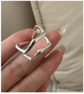 Macro detail of silver geometric layered ring with a minimalist rectangular structure