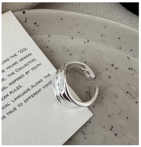 Close-up of S925 sterling silver ring featuring modern wavy texture and interior hallmark