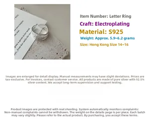 Detail view of S925 sterling silver ring featuring engraved letters and polished finish