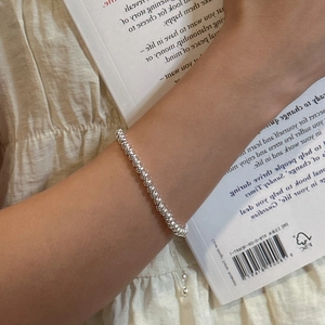 S925 sterling silver beaded bracelet with polished finish on model wrist