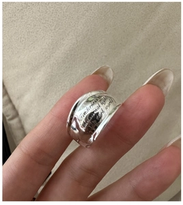 Detailed close-up of wide S925 silver ring featuring elegant script letter engraving