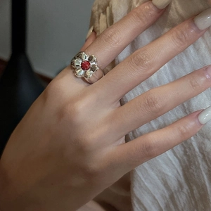 Elegant S925 sterling silver ring featuring a red natural stone flower design on finger