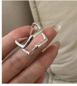 Macro shot of S925 sterling silver double-layer geometric ring on a soft fabric background