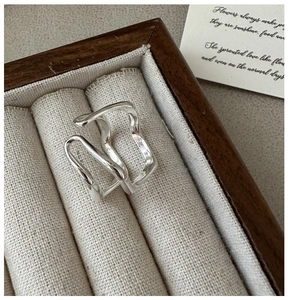 Detailed view of polished S925 sterling silver double-layer wavy ring in a jewelry box