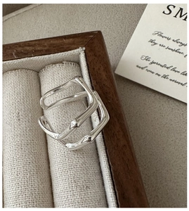 Detail of double-layer silver wave ring with bamboo texture in a wooden jewelry box