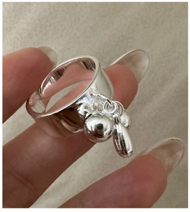 Close-up of S925 sterling silver wide band ring featuring a unique water drop pendant