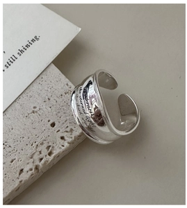 Detailed macro view of S925 silver ring featuring engraved inspirational letters on a stone