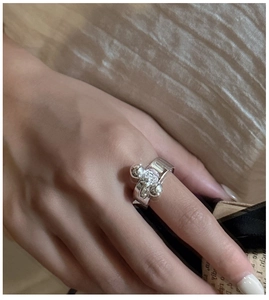 Detailed close-up of a sterling silver water drop ring featuring triple sphere accents
