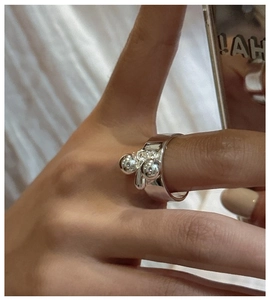 Close-up of S925 sterling silver water drop ring with dual metal spheres on hand
