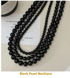 Close-up of multi-layer glossy black bead necklace with elegant mirror finish beads