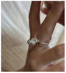 Detail of adjustable S925 sterling silver ring with three small bead accents on hand
