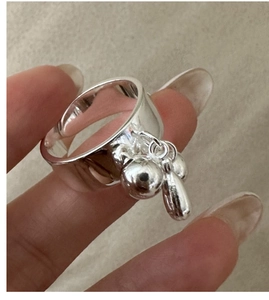 Close-up of S925 sterling silver ring with liquid metal drop and ball charms detail