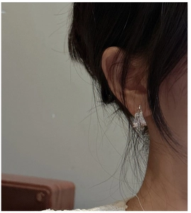 Detail of S925 sterling silver earrings with irregular textured finish on model