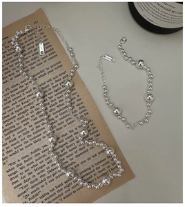 Close-up of Ag925 sterling silver beaded multi-layer necklace and bracelet jewelry set
