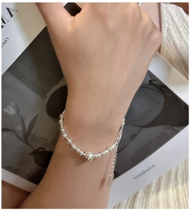 Close-up of S925 sterling silver beaded bracelet with adjustable chain on a female wrist