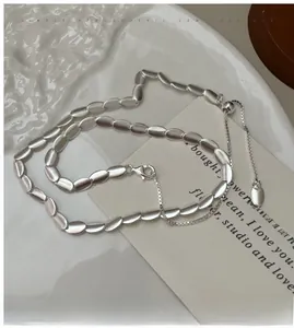 Macro view of adjustable S925 silver scale link necklace with matte frosted finish
