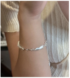 Macro detail of matte S925 silver beaded bracelet showing texture and adjustable chain