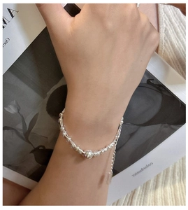Detailed view of the S925 sterling silver beaded bracelet with adjustable chain on wrist
