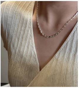 Close-up of S925 sterling silver frosted bean necklace on woman's collarbone