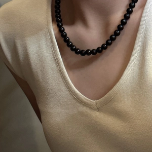 S925 sterling silver necklace with polished black glass beads shown on a model neck