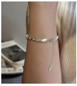 Detail of S925 sterling silver beaded bracelet with adjustable chain on woman's wrist