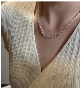 Detailed close-up of S925 sterling silver frosted bead chain necklace on neck