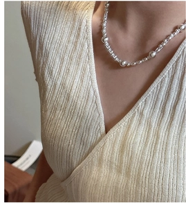 Detailed view of 925 sterling silver beaded layered necklace worn on model neck