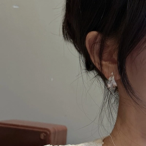 Minimalist S925 sterling silver hoop earrings with irregular textured molten design on model