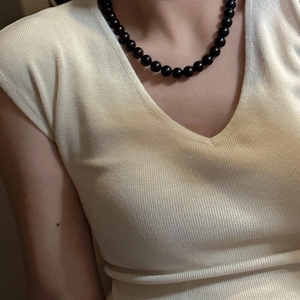 S925 silver black beaded necklace with glass crystal beads on woman wearing beige sweater
