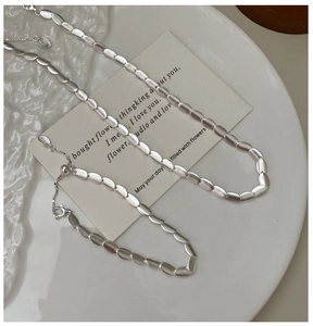 Detailed view of matte S925 silver beaded necklace and bracelet with adjustable chains