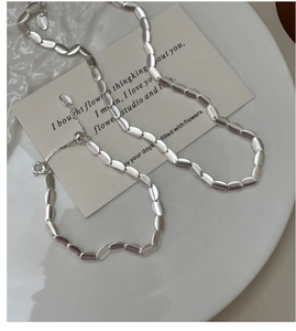 Detail of adjustable sliding buckle and matte silver beads on necklace and bracelet set
