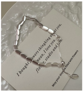 Macro detail of adjustable S925 sterling silver bead bracelet with matte finish on card