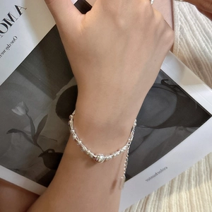 Minimalist S925 sterling silver beaded bracelet with adjustable chain on a female wrist